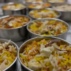 Our homemade biryani, portioned and ready for delivery. Each container is filled with aromatic rice and tender pieces, promising a flavorful meal.