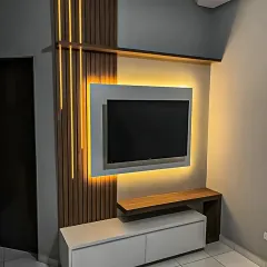 A bold and modern TV wall design featuring dramatic vertical LED strips and a floating console. The mix of dark wood and light grey panels creates a high-contrast, contemporary aesthetic.