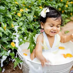 A fun and refreshing milk bath photoshoot is perfect for a summer baby. The bright yellow flowers, fresh oranges, and happy splashes create such a vibrant and joyful image.