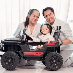 A picture-perfect family portrait. We used a fun toy car prop to engage the baby and bring genuine smiles to everyone's faces.