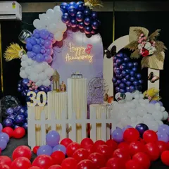 This wide shot shows the full 30th anniversary decoration, with red balloons scattered on the floor to add a pop of color and fill the space. We can customize the color scheme to match your preference.