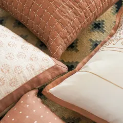 From carved blocks to cozy corners. This image shows a collection of our block-printed and stitched cushions in earthy, terracotta hues, showcasing stories told in every stitch and pattern.