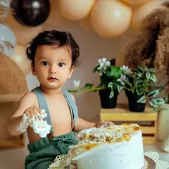 That moment of realization when they figure out the cake is all for them. This boho setup provides a beautiful, neutral backdrop for these priceless first birthday memories.