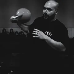 A candid moment with one of our kettlebell coaches. The focus and intensity are real, even between takes.