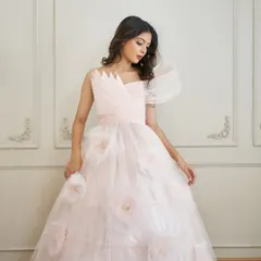 A detailed shot of the 'Carol' gown's bodice, highlighting the intricate wired draping and the soft texture of the 3D flowers on the skirt.
