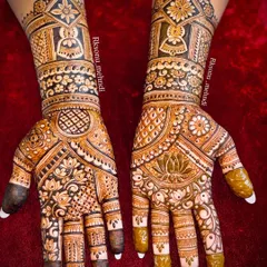 This is a wonderful example of full-coverage bridal mehndi, where both hands are adorned with a dense and symmetrical design. The use of bold lines and delicate fills creates a striking contrast, featuring geometric patterns and floral motifs for a classic bridal look.
