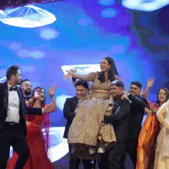 The grand finale of a couple's performance, with friends lifting the bride up in celebration. These high-energy moments are what make a sangeet unforgettable.