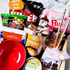 The ultimate K-Drama survival kit. This hamper has everything for a perfect binge-watching session: multiple packs of ramen, topokki, a ramen bowl, chopsticks, and Korean skincare.