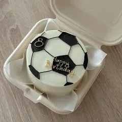 We can bring any hobby or passion to life on a cake. This football-themed bento cake was a huge hit, featuring hand-piped details and custom gold lettering for a fan's special day.