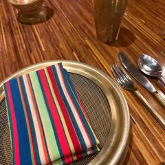 The small details make the meal. A colorful striped napkin and brass tableware at Loya, Taj Palace, show the restaurant's commitment to a luxurious, traditional North Indian dining experience.