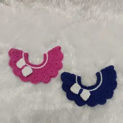 This image shows two of my scalloped collars, one in bright pink and the other in royal blue. Both feature a crisp white bow, and they can be sewn on or worn as a detachable accessory.