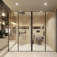 A view of the glass-enclosed shower and toilet area in the travertine spa bathroom. The black framing adds a modern, graphic contrast to the warm stone, showcasing our attention to detail in creating functional, separated zones.