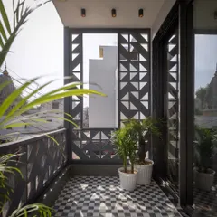 In a dense Meerut neighborhood, the Hikari House facade negotiates privacy and openness. We used custom cast-concrete screens, assembled like Tetris blocks, to filter views and soften sunlight, creating a serene balcony space that feels both connected to the city and peacefully secluded.