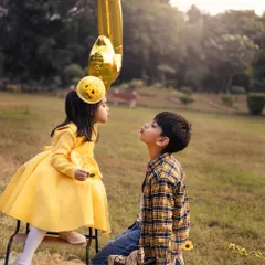 The original shot from a sunny birthday session in the park. The bright yellow outfits and sunflowers create a cheerful and vibrant theme for this sibling portrait.