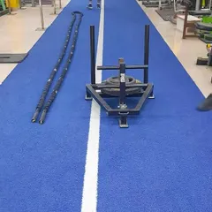 The power sled and battle ropes ready for action on our turf track. These tools are fantastic for high-intensity interval training (HIIT) that torches calories and builds incredible stamina.