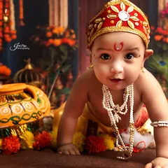 A close-up shot of a baby boy dressed as Krishna, crawling towards the camera. His direct gaze and sweet expression are simply heart-melting.