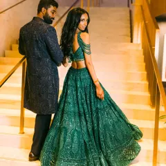 A stunning "over the shoulder" moment. Nisha's emerald green Falguni Shane Peacock lehenga for the Sangeet was all about movement and sparkle, perfectly complemented by Vishal's custom-embroidered dark sherwani.