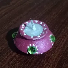 This is my modern take on the traditional diya. Each terracotta pot is hand-painted and filled with wax by me, perfect for celebrating a Green Diwali and bringing an authentic Indian feel to your festival decorations.