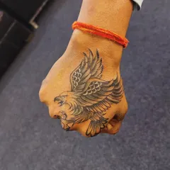 After: We covered the old symbols with a bold black and grey eagle. The new tattoo's size and detail provide complete coverage and a much more powerful visual statement.