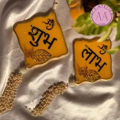 Welcome prosperity with these yellow 'Shubh Labh' hangings, featuring beautiful pearl tassels. Perfect for your home entrance during Diwali.