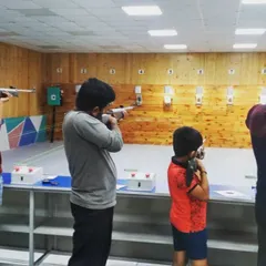 A group of shooters, including a young boy, learning the fundamentals of air rifle shooting. We ensure a safe and supervised environment for all ages.