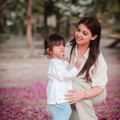 A mother and her daughter amidst a carpet of pink flowers. We use the beauty of nature to create magical backdrops for your family portraits.
