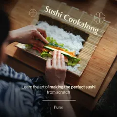 A participant in our Pune workshop learns the art of making the perfect sushi roll from scratch. This overhead shot shows the careful layering of ingredients on the bamboo mat.