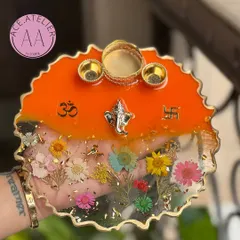 A closer look at one of my custom floral pooja thalis. This 10-inch resin thali features real dried flowers preserved forever, along with a Ganesha idol, brass bowls, and auspicious symbols for your daily rituals or festive celebrations.