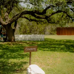 A charming detail shot of the "Ceremony" sign, setting the scene for a rustic, outdoor wedding in Texas.