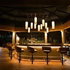 This is the 360-degree bar at the Bangalore Golf Club, a project with deep personal meaning for me. My design uses layered, low-level illumination and a dramatic central pendant cluster to foster a relaxed, glare-free ambiance where pools of light and shadow define the space.