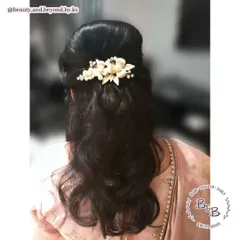This half-up hairstyle is universally flattering and works for all age groups. I created a soft bouffant at the crown for volume and added gentle waves, finishing the look with a beautiful floral accessory.