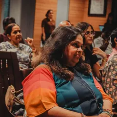 A colorful and engaged audience member listening intently. Our community is a diverse mix of people from all walks of life, united by a love for stories.
