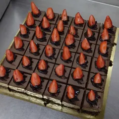 Our chocolate strawberry dessert, sliced and ready to serve. Each square is a perfect portion of fudgy, fruity goodness.