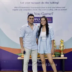 Standing with a participant in front of the event backdrop. These photo opportunities are important for capturing the moment and giving employees a great memory to share from their corporate wellness event.
