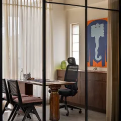 My personal cabin is designed for privacy while maintaining a visual connection to the studio. The desk itself embodies our philosophy, pairing a sourced vintage teak leg with a contemporary tabletop, a true juxtaposition of traditional and modern design.