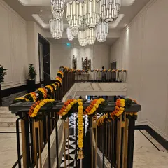 To extend the festive atmosphere, I decorated the hotel's grand staircase railings with matching marigold garlands. This ensures a cohesive decorative theme from the entrance throughout the main public areas of the venue.
