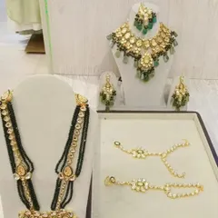 For a touch of royalty, rent this stunning Kundan and emerald green bead jewellery set. It includes a choker, long necklace, and matching earrings.