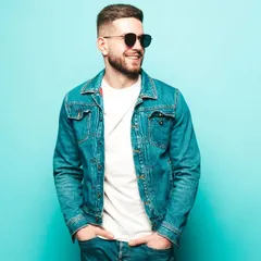A model in a classic denim jacket and sunglasses against a bright blue background. This colorful, energetic style is great for social media and campaigns targeting a younger audience.
