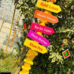 Quirky signs add so much personality. For this Haldi, I created these colorful arrow signs with fun commands like "Nacho Jappo" and "Photo Khichoo" to guide guests and get them in the party mood.