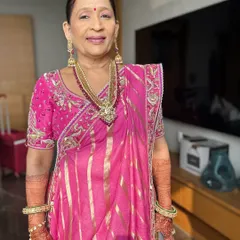 A full-length portrait showcasing the mother of the bride's complete look. The makeup is designed to be radiant and polished, ensuring she looks and feels her best on this special day.