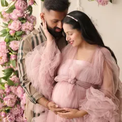 We believe maternity photos should be as magical as the life you're creating. In this fine-art maternity portrait, we used a cascade of pink peonies and a flowing tulle gown to create a dreamy, romantic atmosphere for the expecting couple.