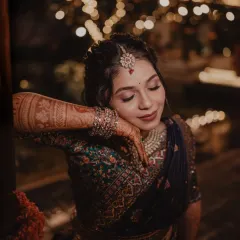 A serene and beautiful close-up of the bride, her intricate henna and jewelry on full display.