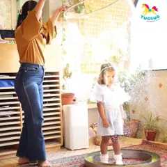A child stands in awe as a giant bubble forms around them. This unique experience is a highlight of any party and creates a truly magical moment.