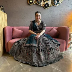 Look at this beautiful bride in my signature dark teal velvet lehenga. The intricate embroidery and full flare make it a truly royal choice for a wedding reception.