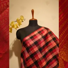 A bold and modern take on tradition, this Kanjivaram features a large-scale check pattern in shades of red, peach, and black.