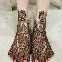 Don't forget the feet! A full traditional foot design with peacocks and elephants adds a regal touch to your complete bridal look. The details here are just as important as the hands.