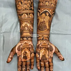 A complete view of a grand bridal mehndi design. The arms are adorned with portraits of the couple, doli scenes, and architectural elements, telling a beautiful story from wrist to elbow.