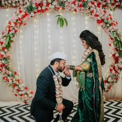 A modern twist on tradition, with the groom-to-be kneeling and kissing his fiancée's hand during their engagement ceremony.