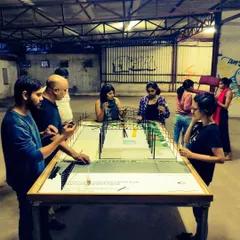 Our team gathered around a scale model of the space during the planning phase, visualizing the future of Bangalore Creative Circus.