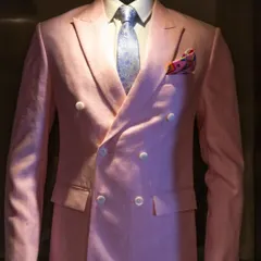 Make a bold statement with this double-breasted pink linen blazer. It's a perfect example of how we tailor classic silhouettes in unexpected, stylish colors for summer events.